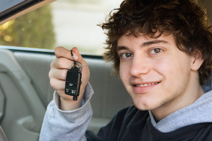 teen boy holding keys