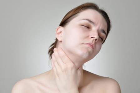 Young woman holding her painful throat