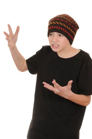 The teenager in a black vest and a hat