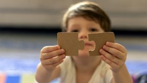 facts about aspergers syndrome - boy with puzzle piecec